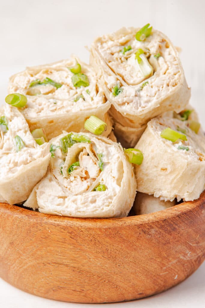 a wooden serving bowl filled with the completed chicken pinwheels recipe