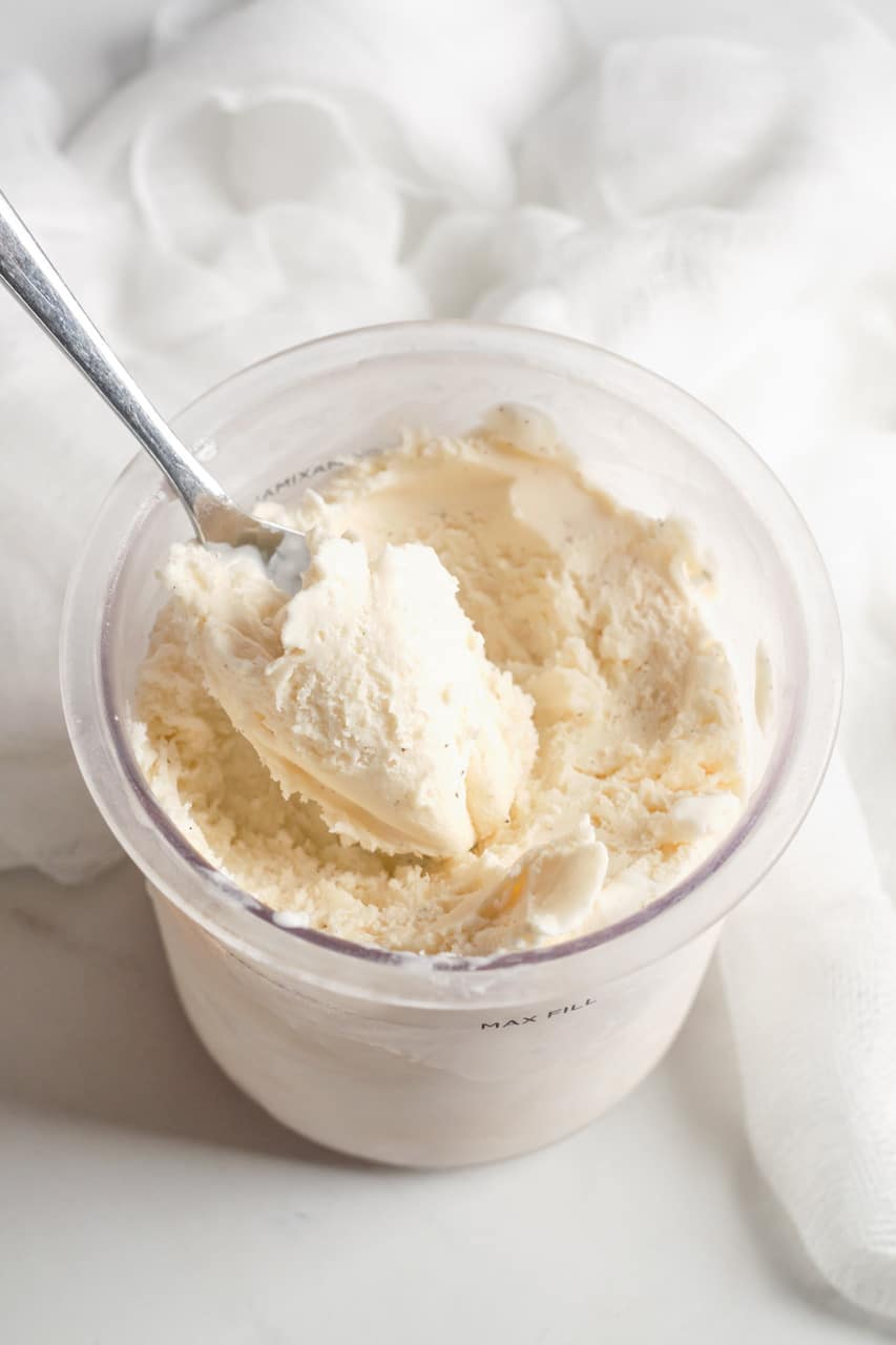 a container of Ninja Creami Vanilla Ice Cream with a spoon inside it