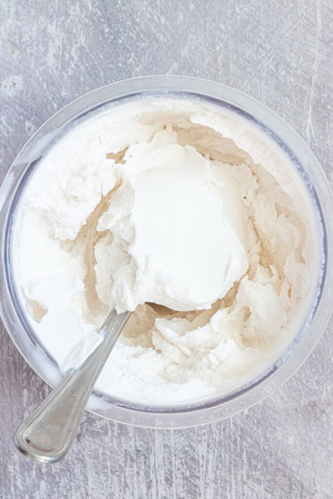 a spoon inside the Ninja Creami Coconut Ice Cream.