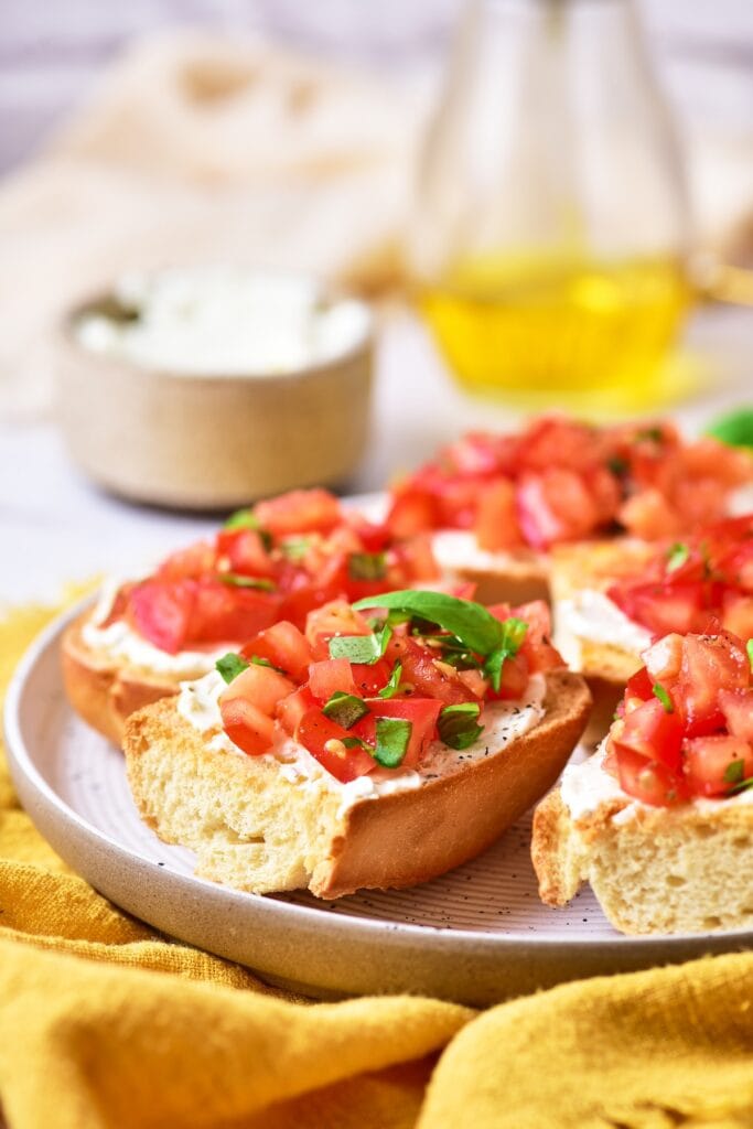 a plate filled of the bruschetta appetizer.