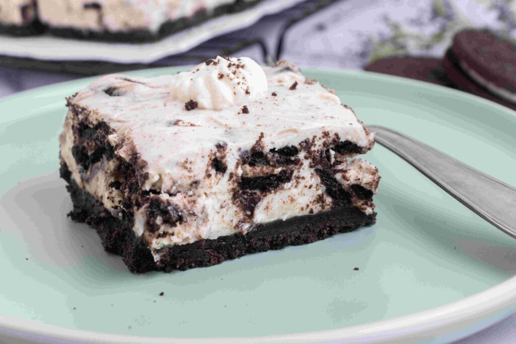 A cheesecake bar that is no bake on a blue plate.