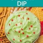 overhead view of a bowl of grinch dip surrounded by crackers and pretzels